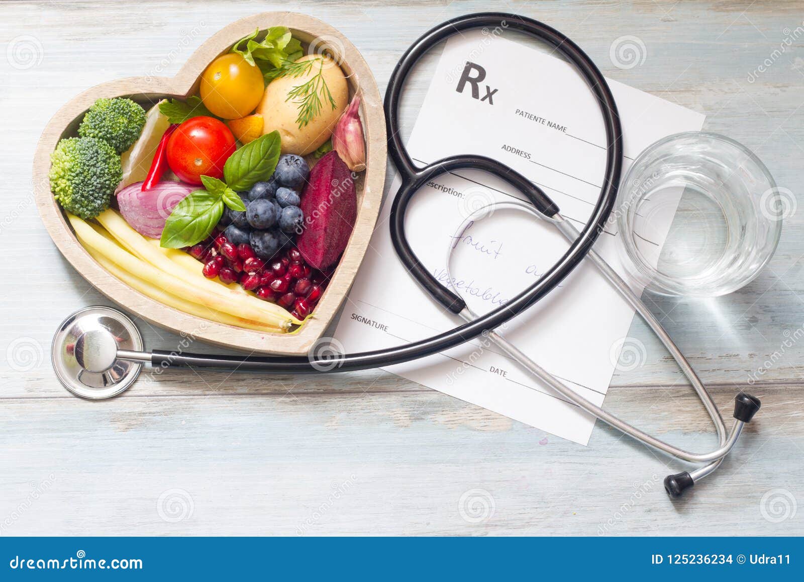 healthy food in heart stethoscope and medical prescription diet and medicine concept