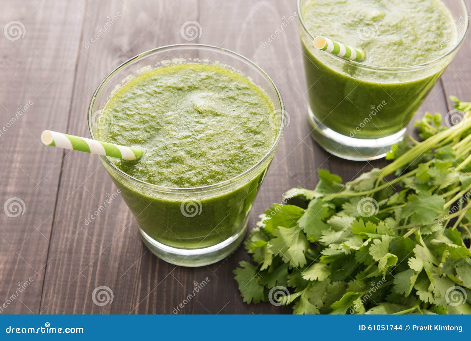 Healthy green vegetables and green fruit smoothie on rustic wood table.