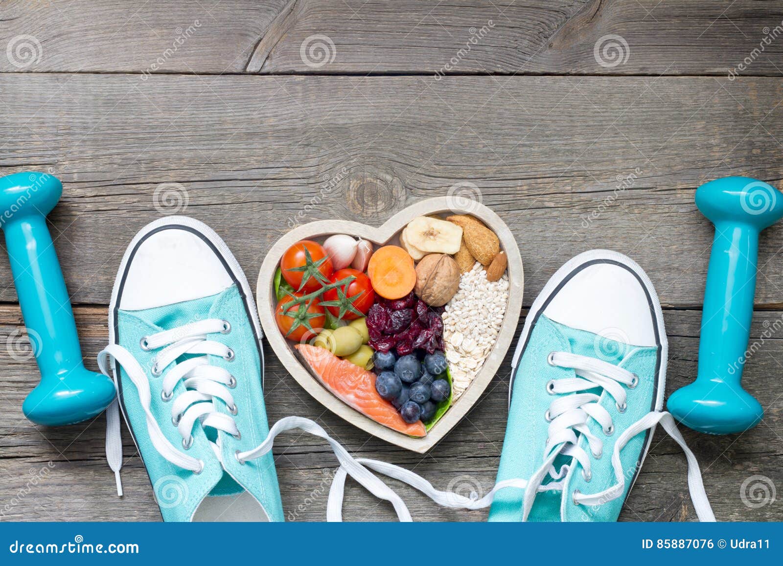 healthy lifestyle concept with food in heart and sports fitness accessories