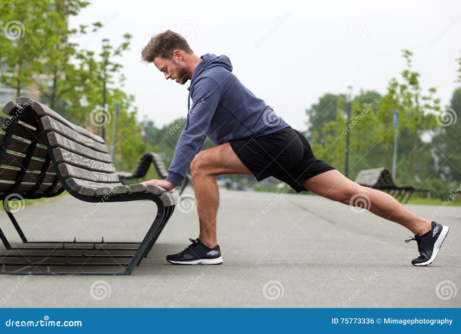 healthy man doing stretch before jog