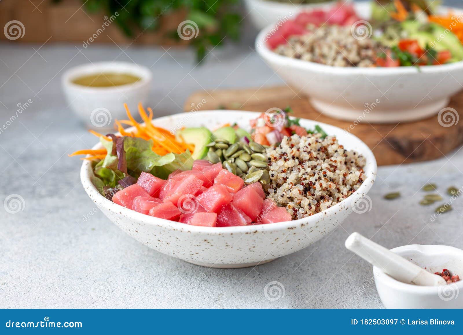 healthy raw tuna bowl with quinoa and vegetales. buddha bowl