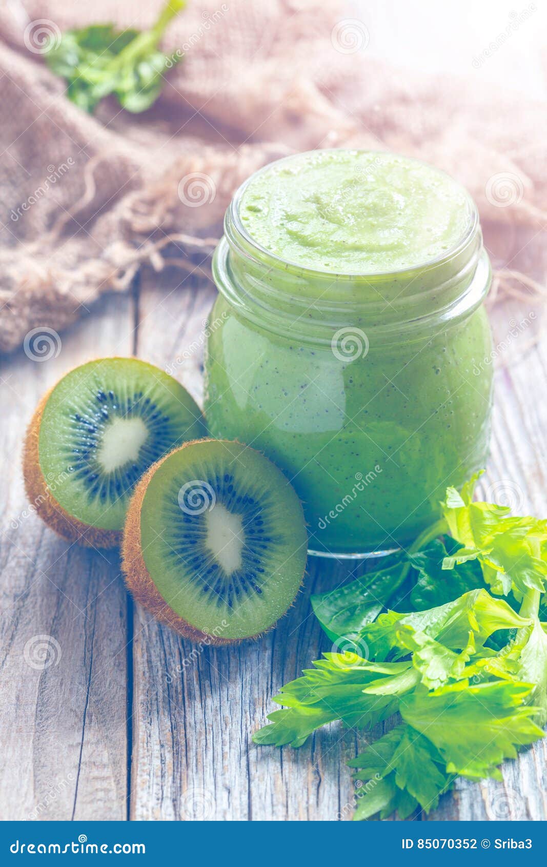 Healthy Smoothie Spinach, Celery and Kiwi Fruit in a Small Glass Stock