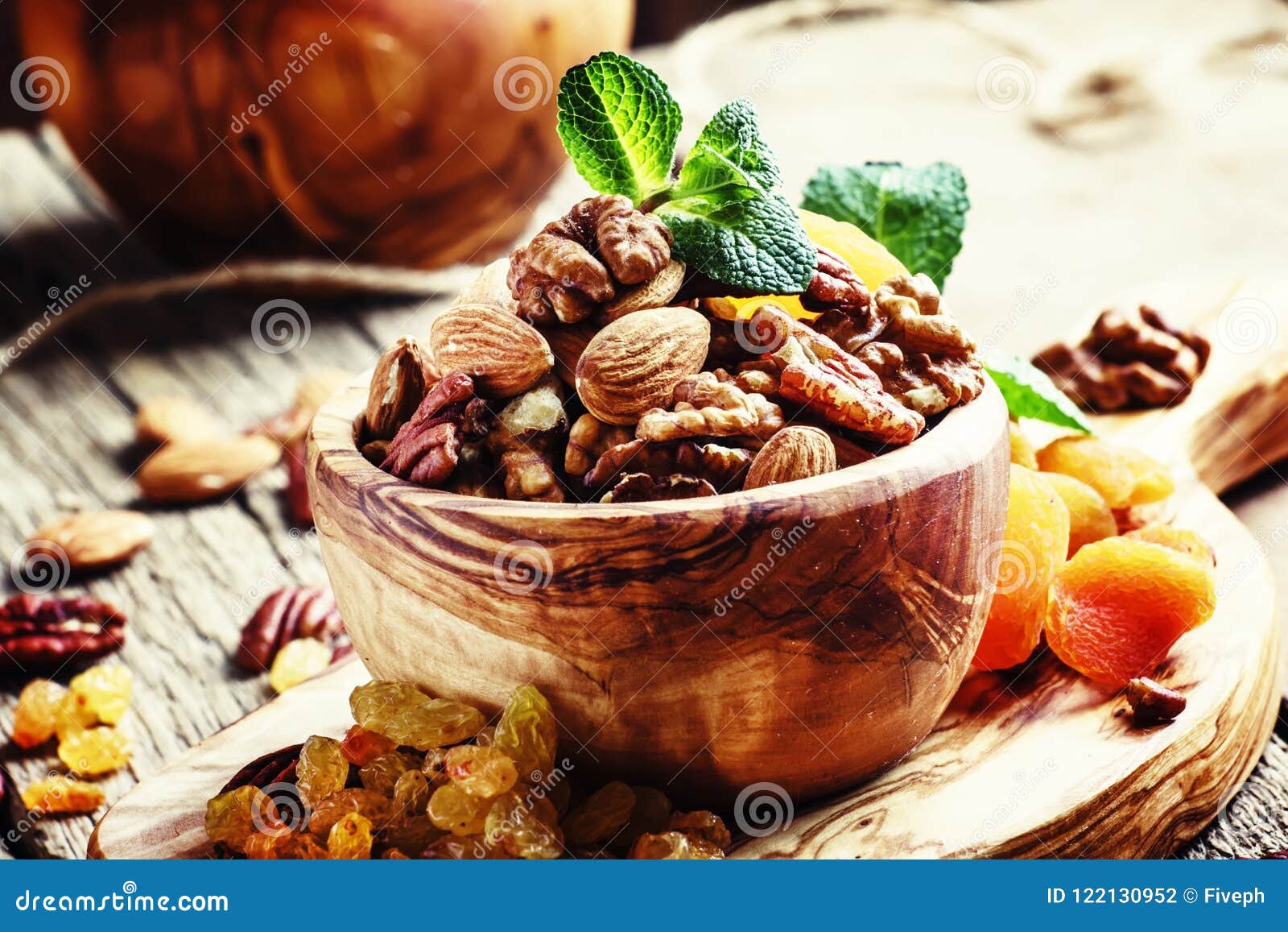 healthy snack: raw nuts and dried fruit, decorated with mint. vi