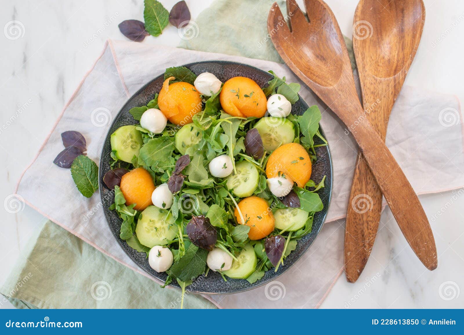 healthy summer salad with melon an mozzarella cheese