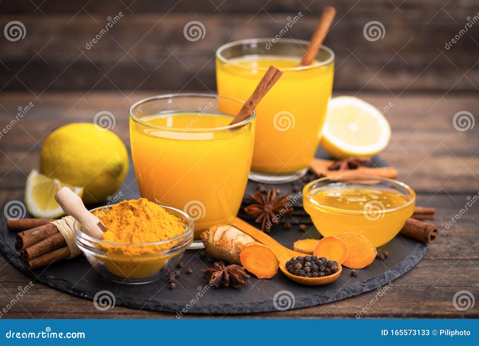 Healthy Turmeric Drink with Honey, Cinnamon, Lemon and Ginger Stock