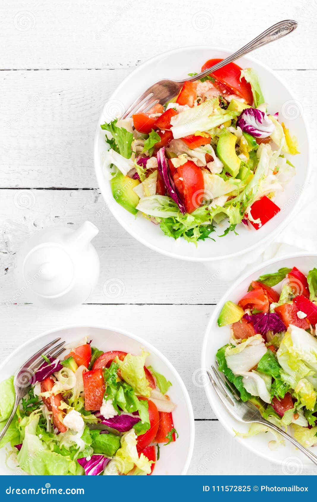healthy vegetable salad with fresh greens, lettuce, avocado, tomato, seet pepper and goat cheese. delicious and nutritious diet di