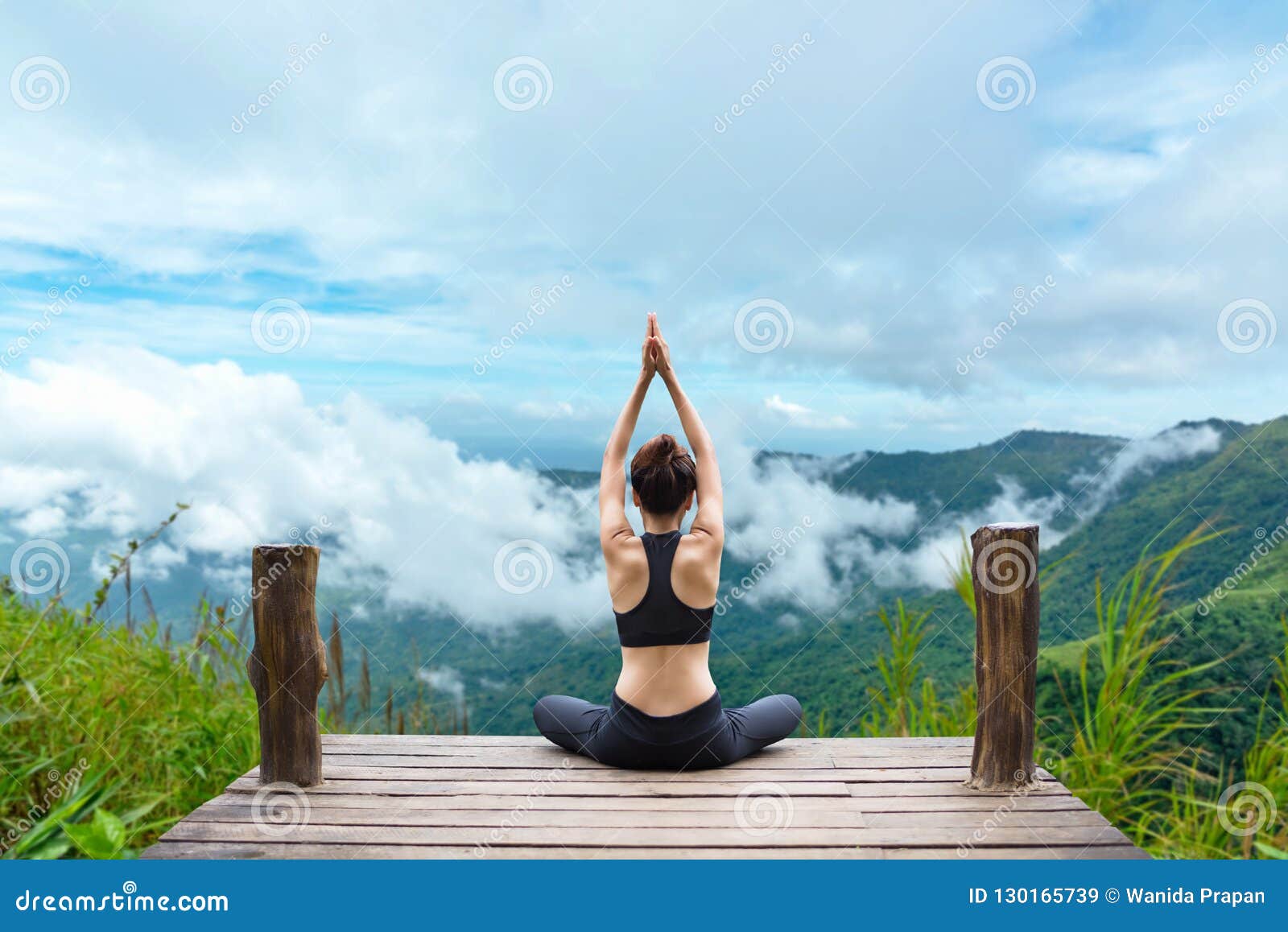 healthy woman lifestyle balanced practicing meditate and zen energy yoga on the bridge in morning the mountain nature