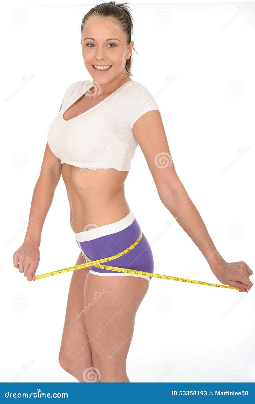 Young Slim Woman Measuring Her Waist by Measure Tape Free Stock Photo