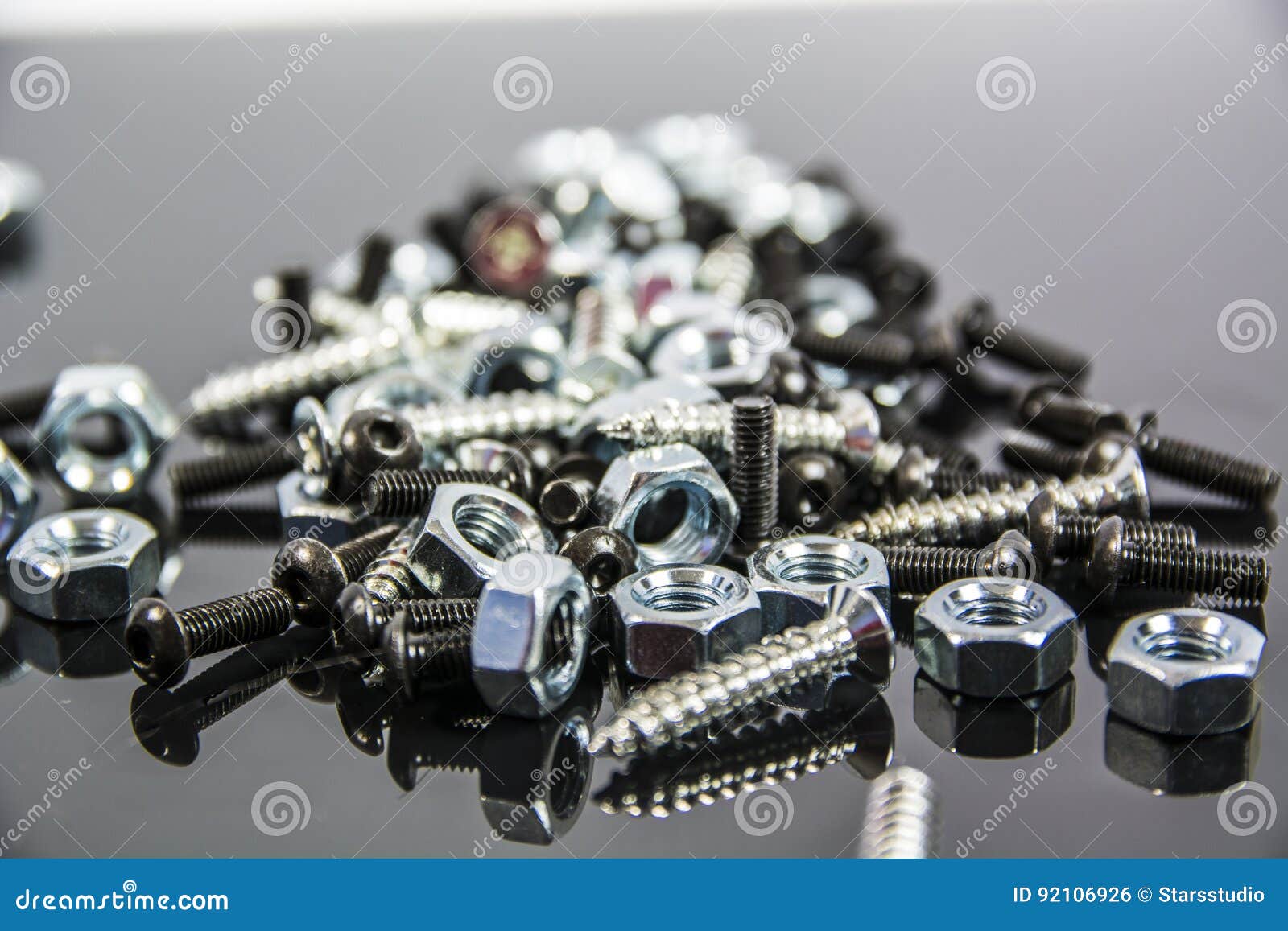 Heap Of Bolts, Screws And Nuts On Neutral Background Stock Photo
