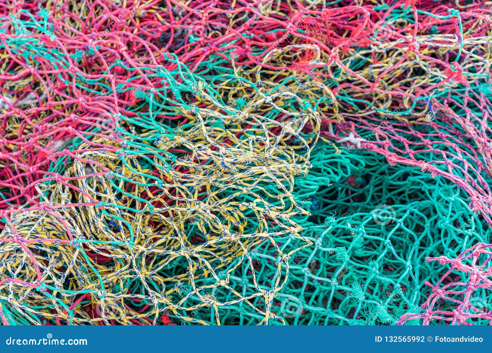 heap of colorful fishing nets at harbor