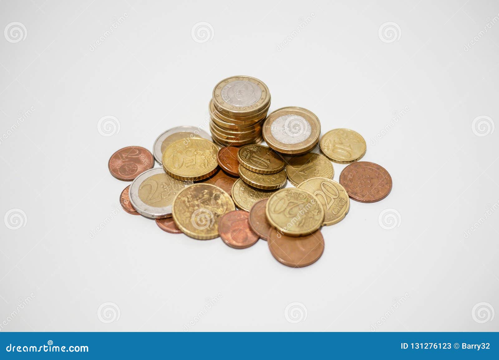 Pile Of Euro And Cents Coins Of Various Denominations On A White Desk