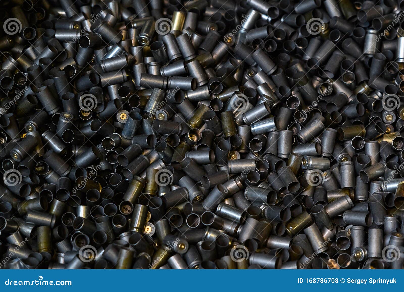 heap of gun bullets. weapon cartridge case sleeve background texture, 9mm. weapon cartridge sleeves.gun bullet pattern close up