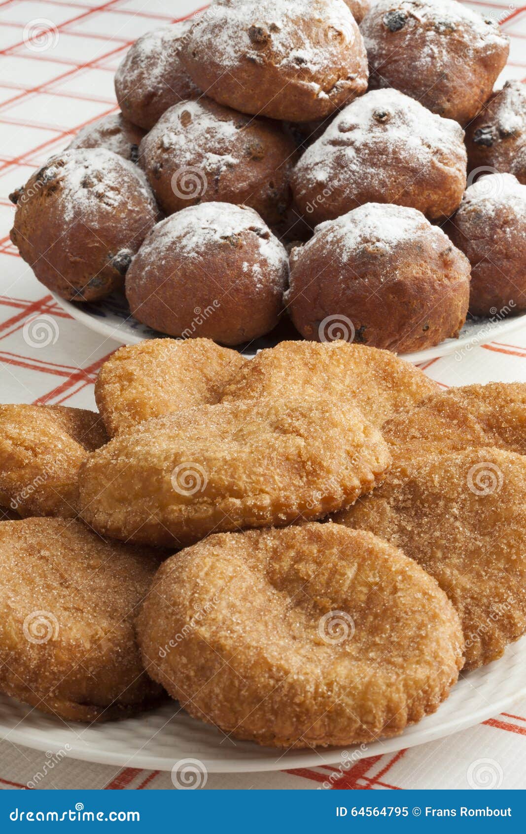 heap of sugared fried fritters called oliebollen and appelflapp
