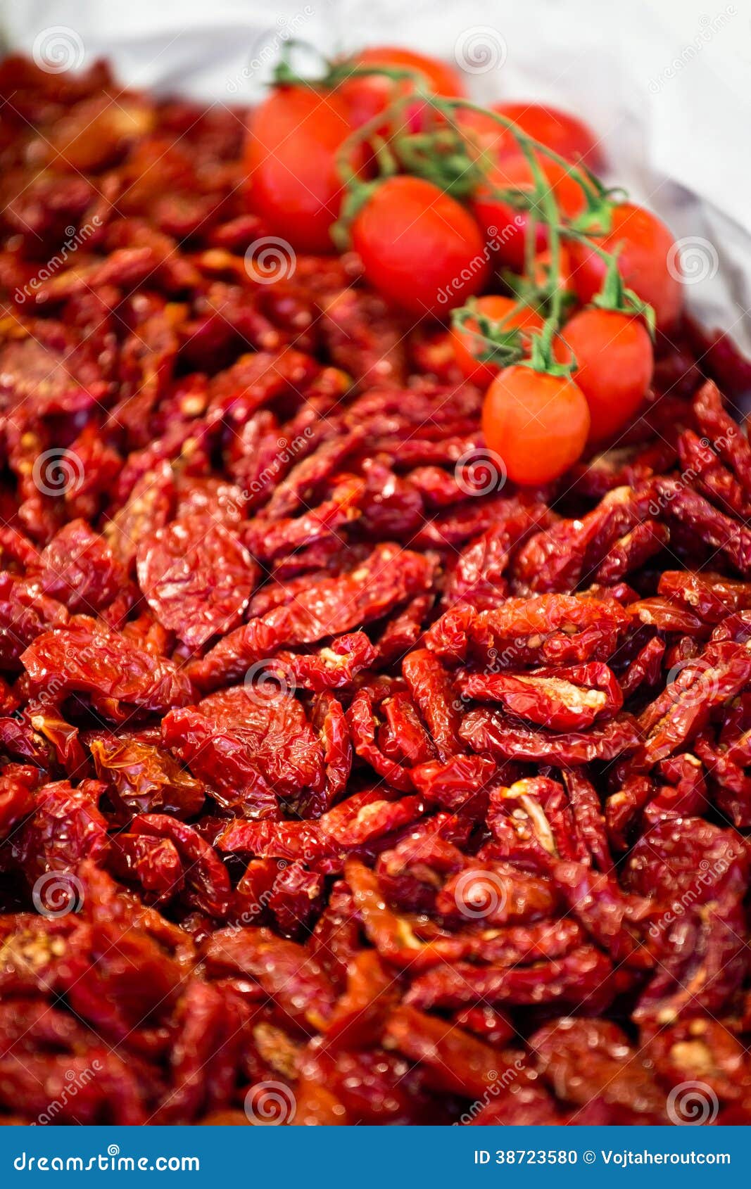 heap of sundried tomatoes with fresh tomatoes