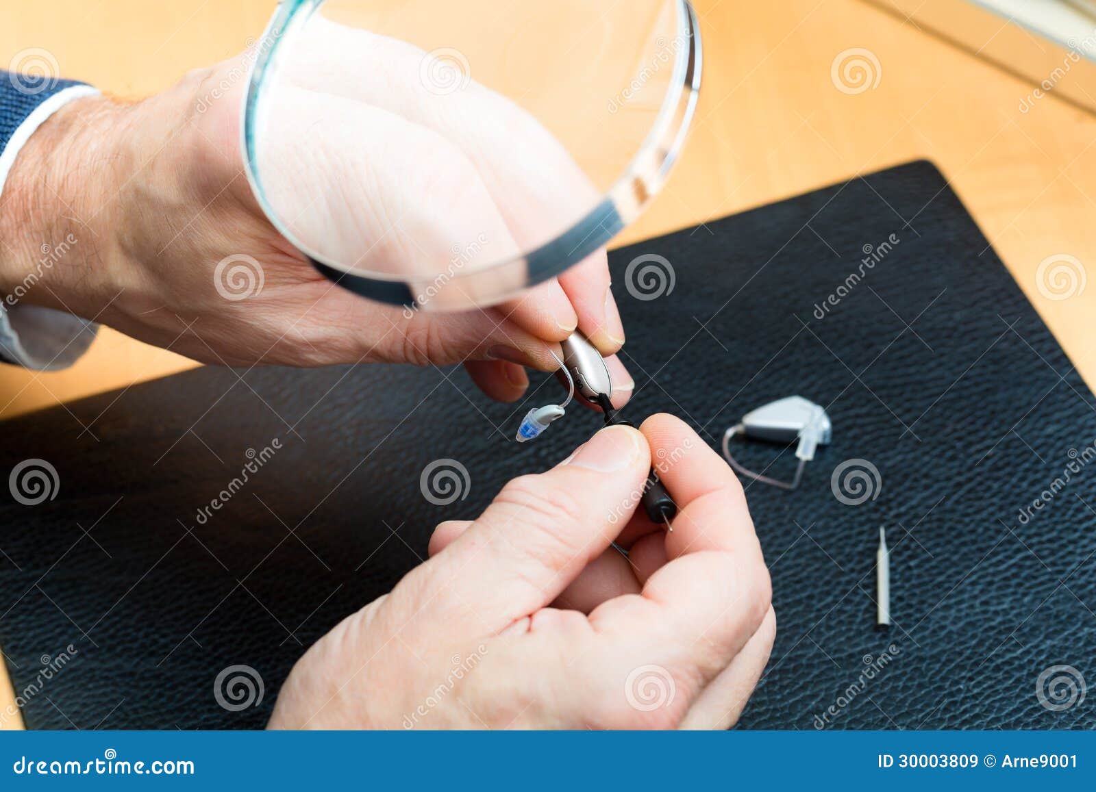 Acoustician Working on a Hearing Aid Stock Image Image of small, male 30003809