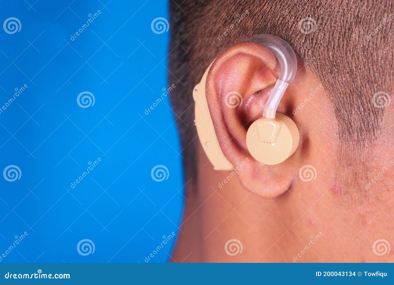Hearing Aid Concept, a Young Man with Hearing Problems. Stock Photo