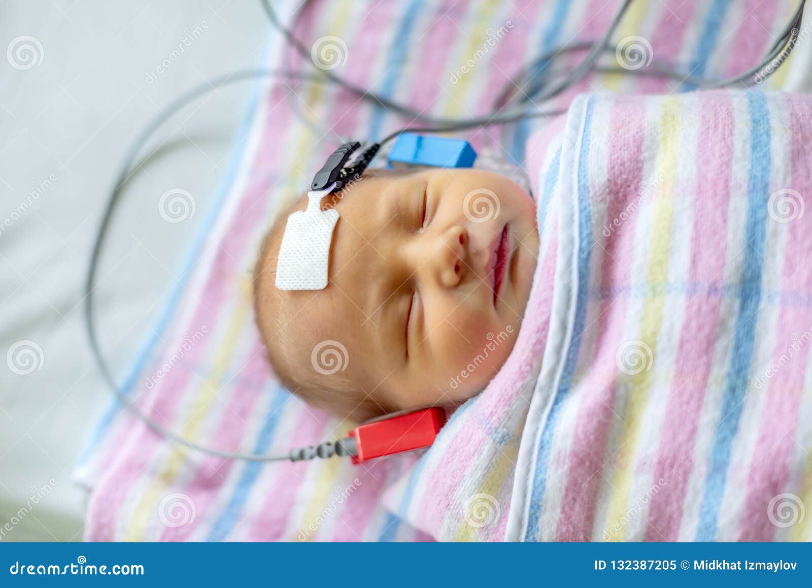 hearing test of a sleeping newborn at hospital