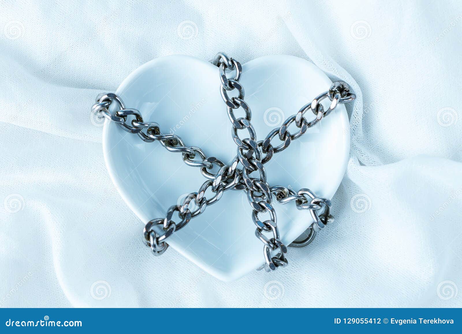 The Heart Symbol in Chains, on a Light Background Stock Photo Image