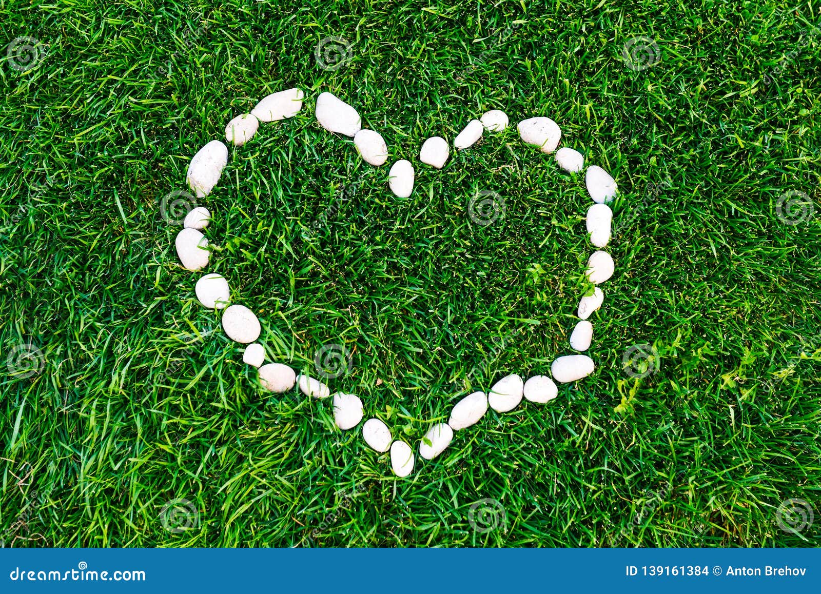 Heart on the Grass Lined with Stones. Valentine`s Day. Romantic Concept
