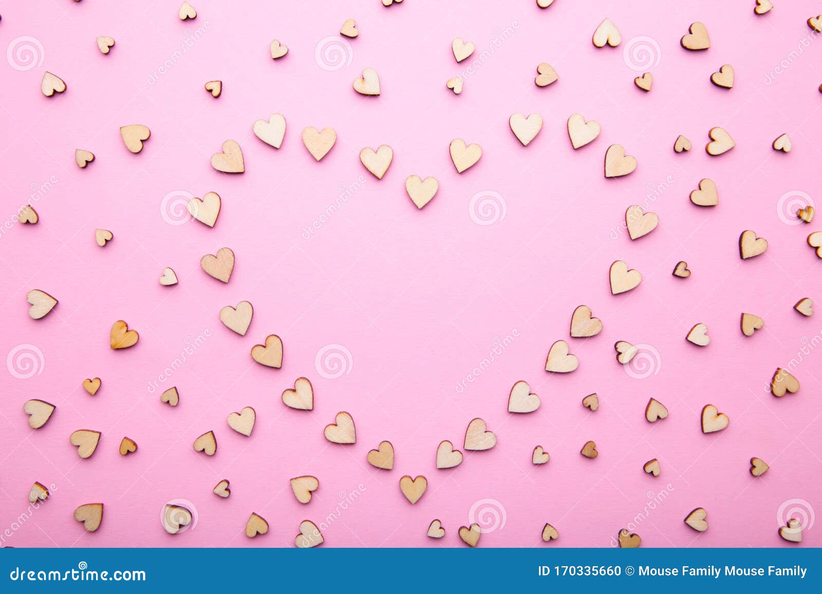 heart from little wooden hearts on pink background