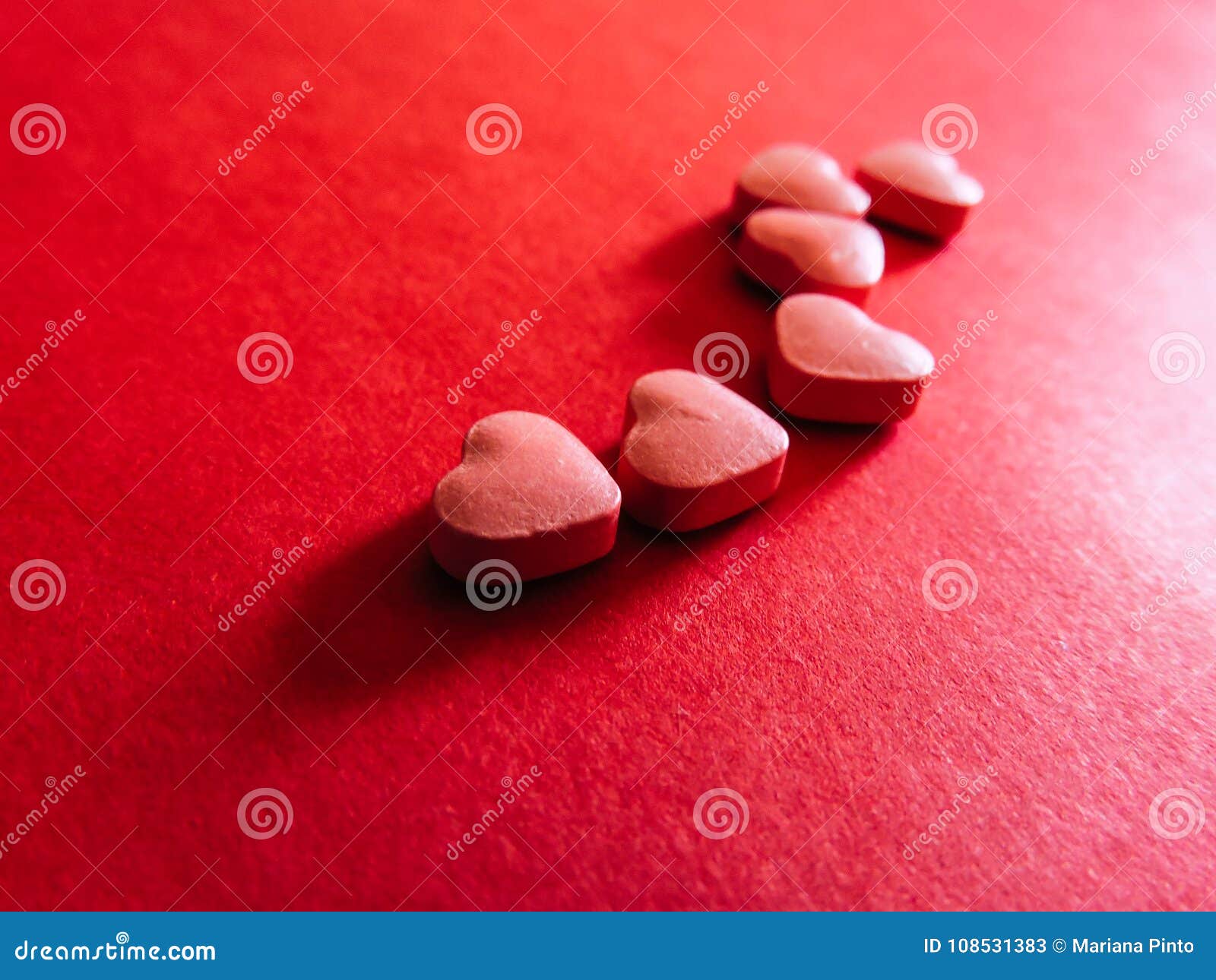 heart pills in red background. valentines day