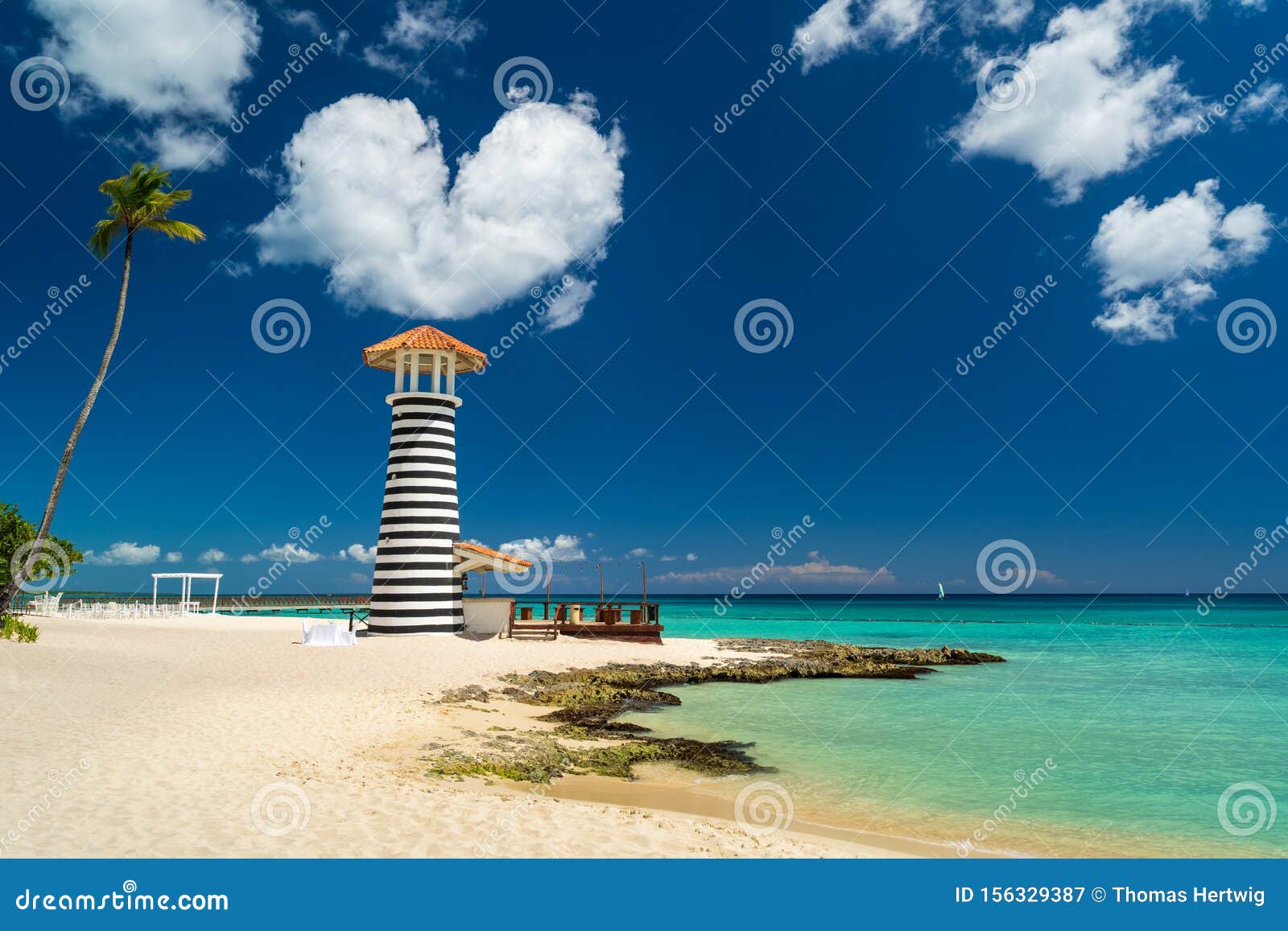 heart d cloud over lighthouse on the beach of the caribbean, dominican republic, bayahibe - love wedding concept