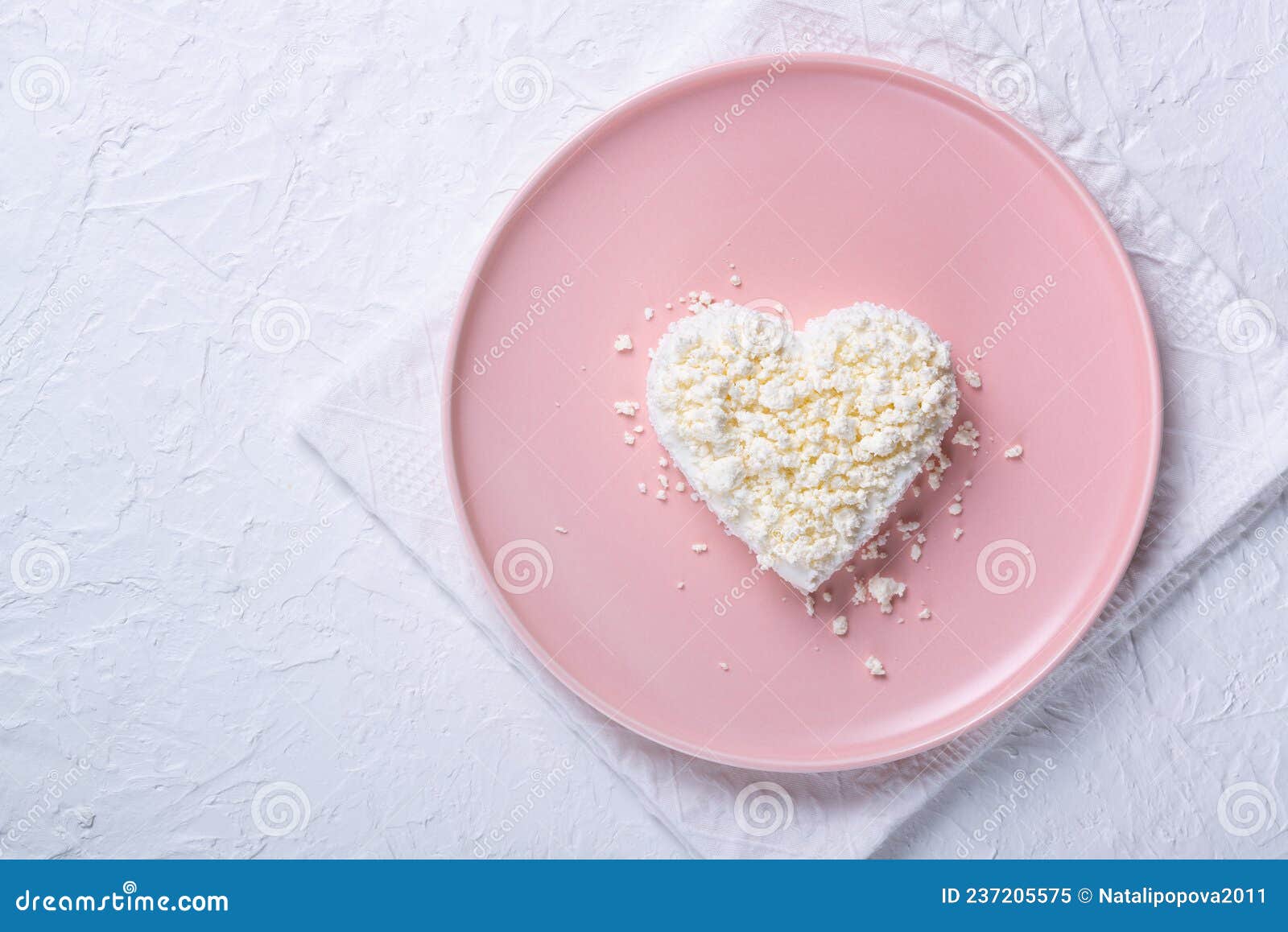 Heart Shaped Cottage Cheese in a Pink Plate on a White Table. Stock