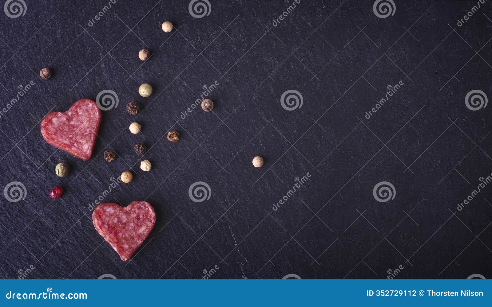 heart d salami on a cutting board, seen directly above. horizontal image.