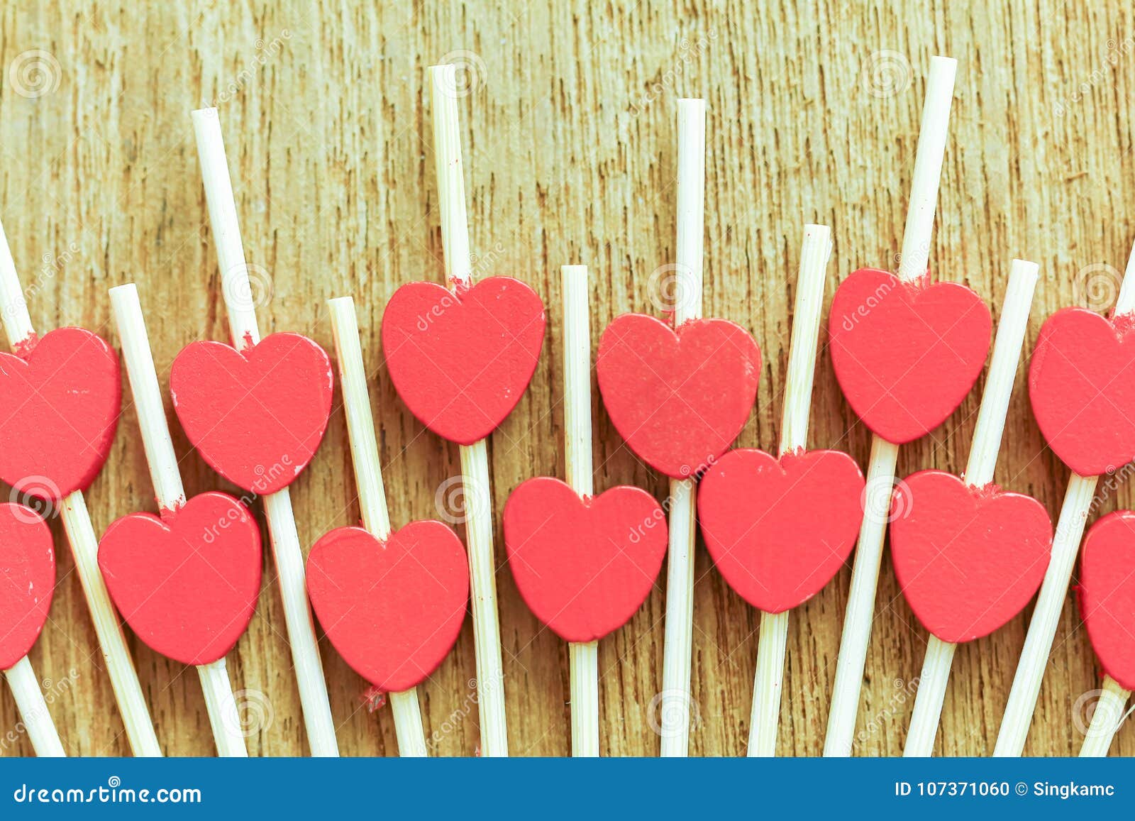 valentines day concept. couple of red glitter hearts on wooden b