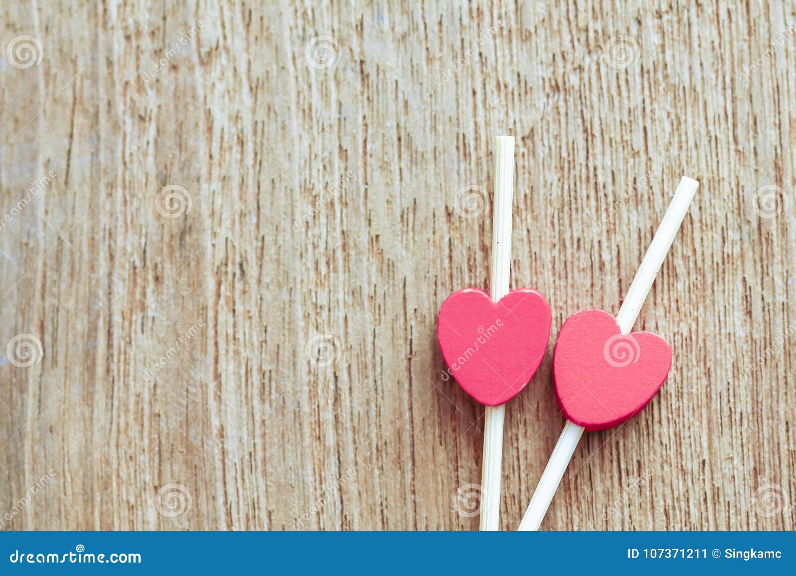 valentines day concept. couple of red glitter hearts on wooden b