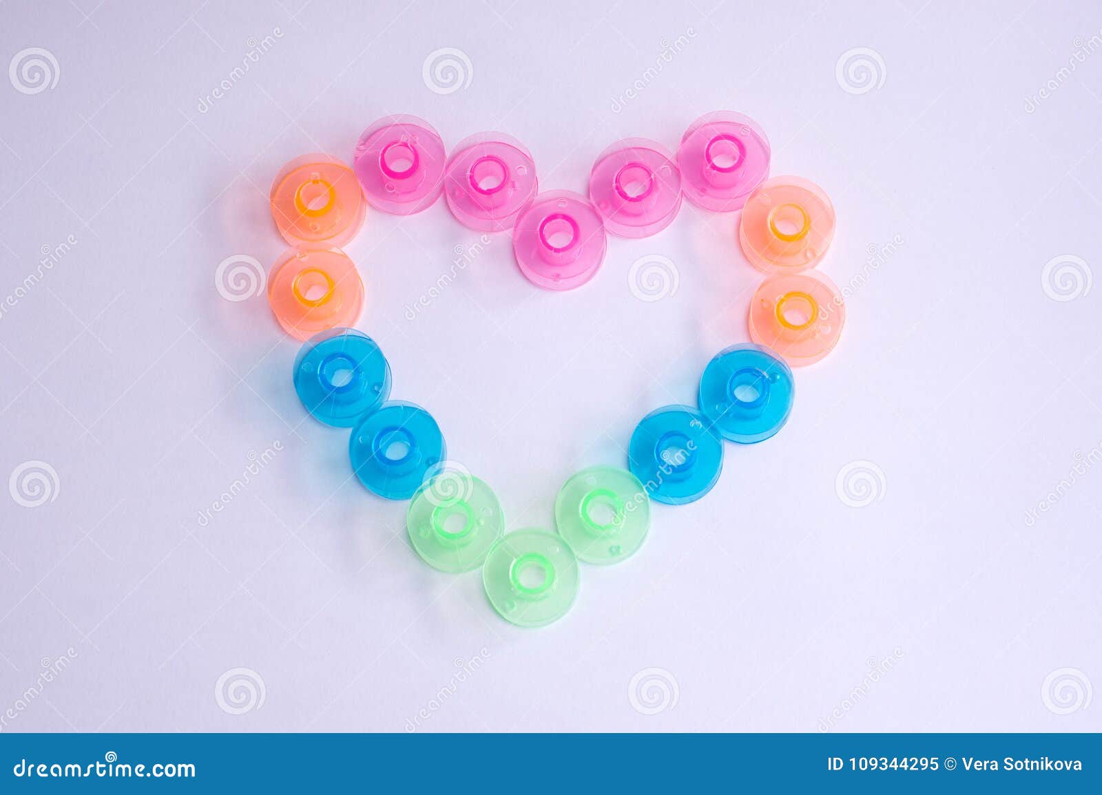 hearts from sewing colorful bobbins on white phonetics. valentin