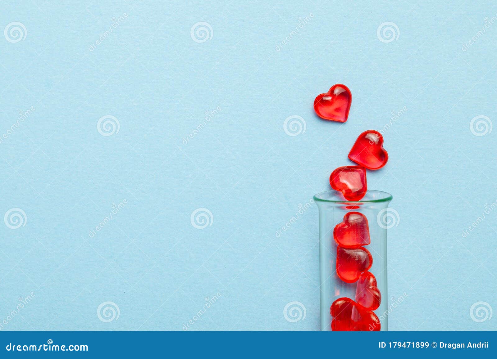 hearts and test tube. baby from tube vitro glass. artificial insemination, ivf. blue background. copy space for text.
