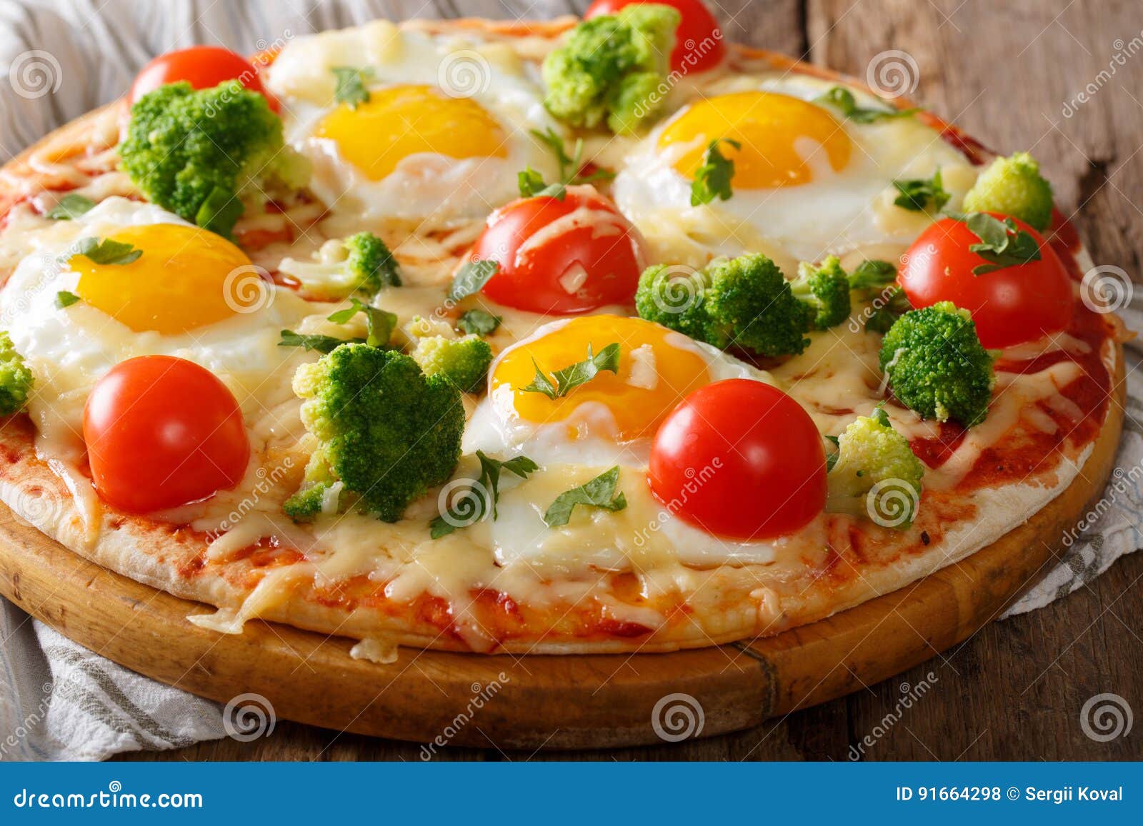 Hearty Breakfast of Pizza with Eggs, Broccoli, Tomatoes Closeup Stock