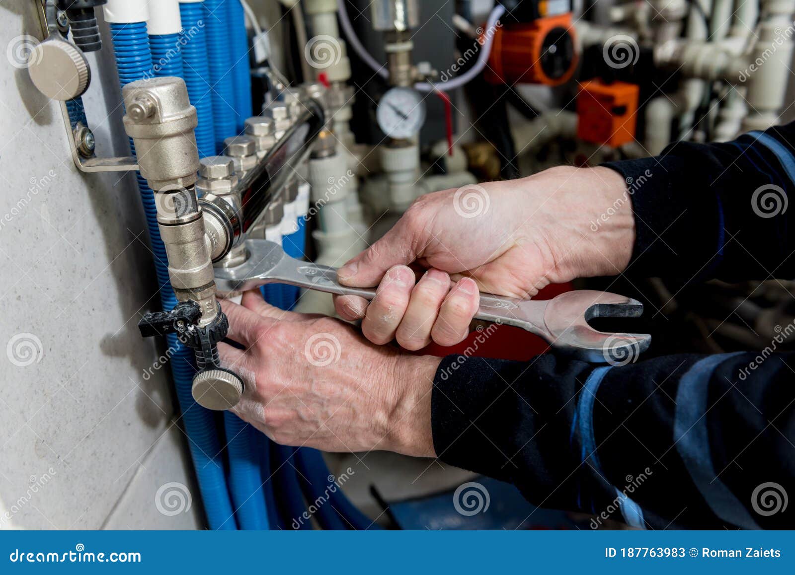 Heating Engineer Installing Modern Heating System in Boiler Room. Stock