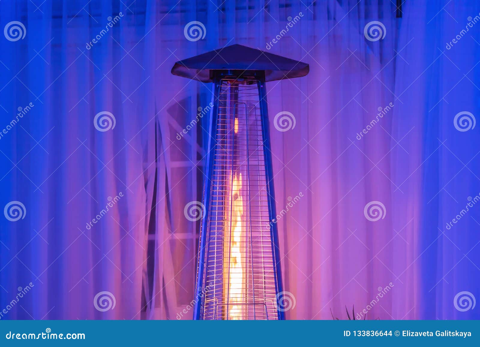 Heating Lamp Heater Placed among the Tables of an Open Cafe Stock Photo