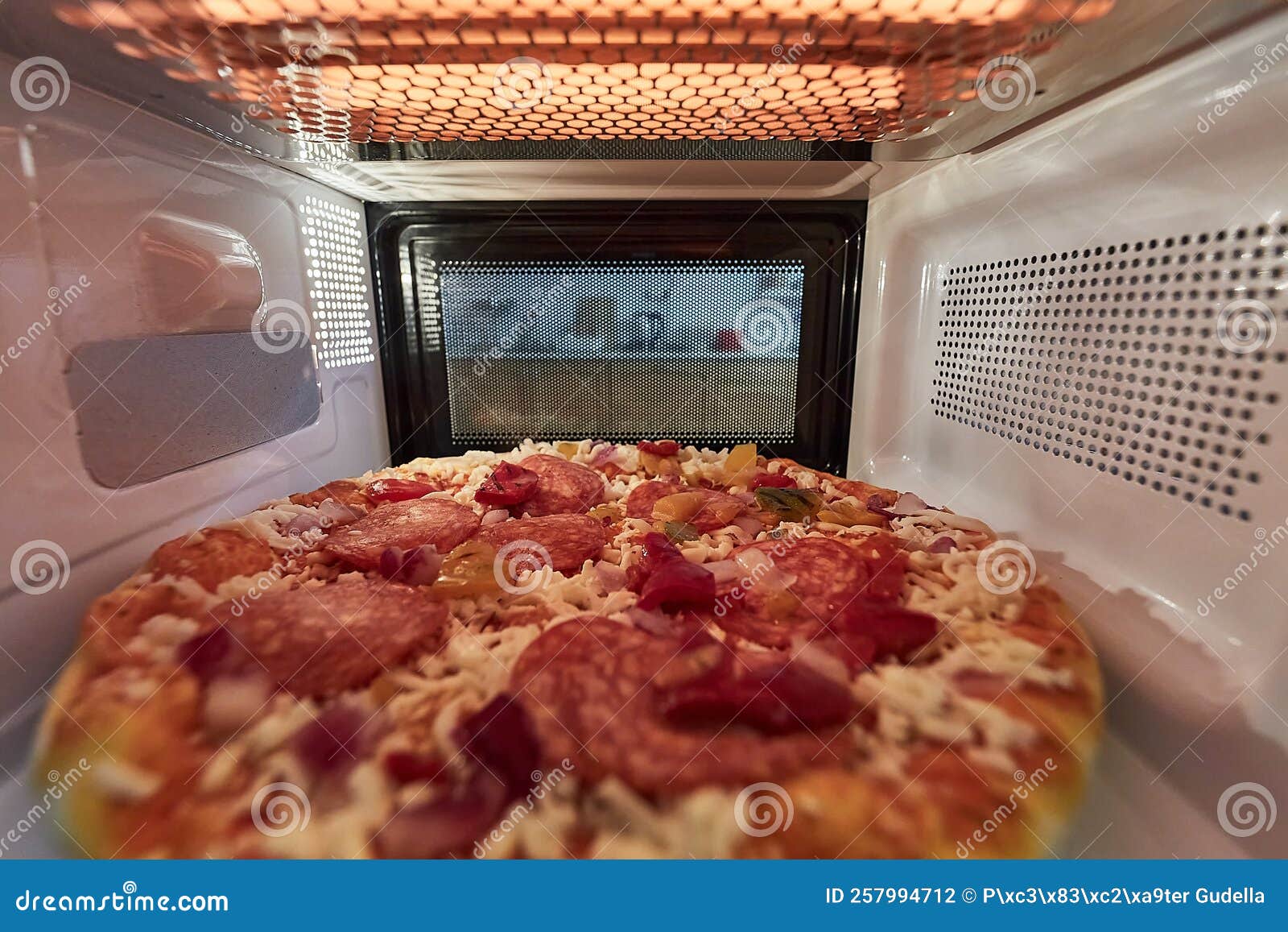Heating Pizza in a Microwave Oven Stock Photo Image of microwaving, reheating 257994712