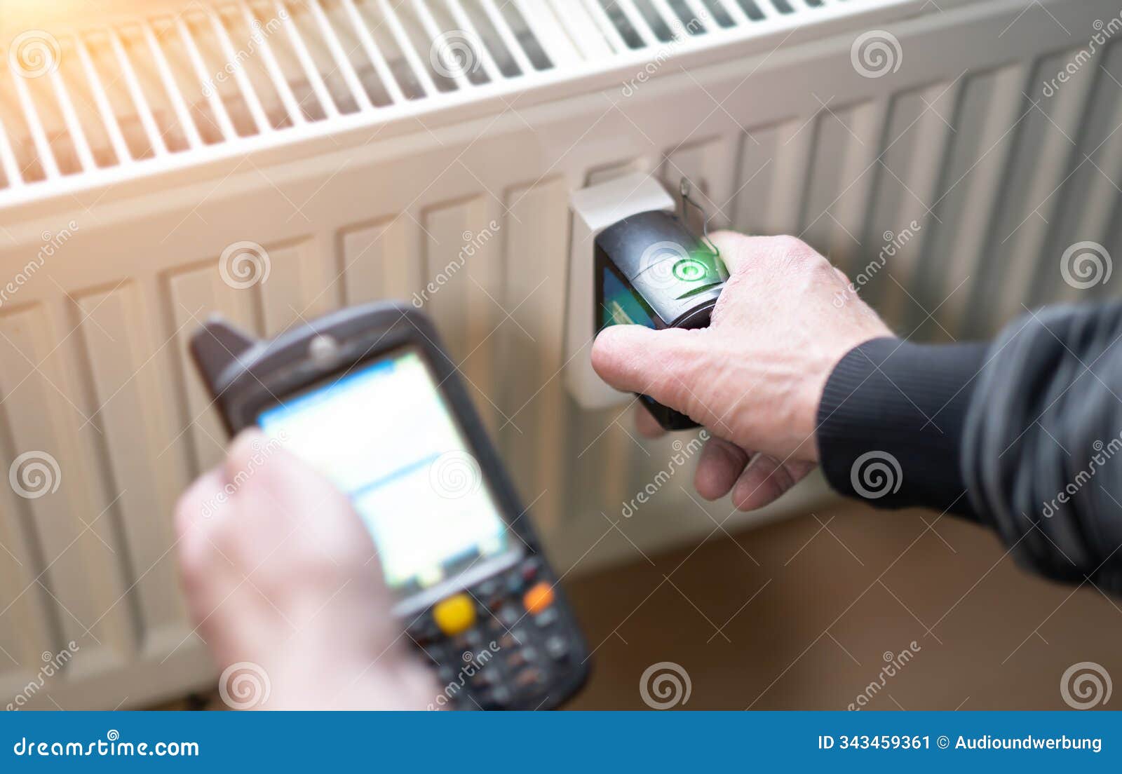 heating system engineer ist adjusting the digital w-lan network thermometer reader on a new thermal radiator