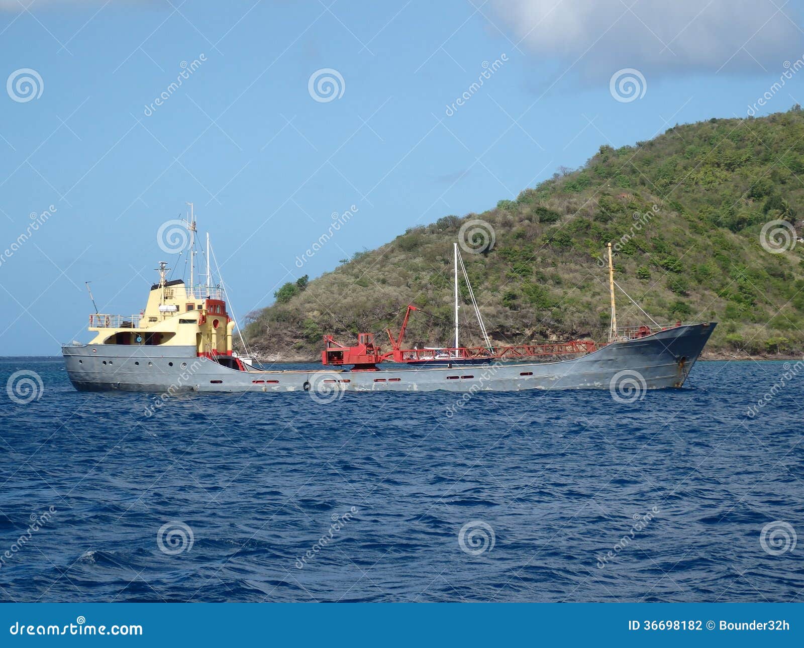 a heavily laden cargo ship at anchor.