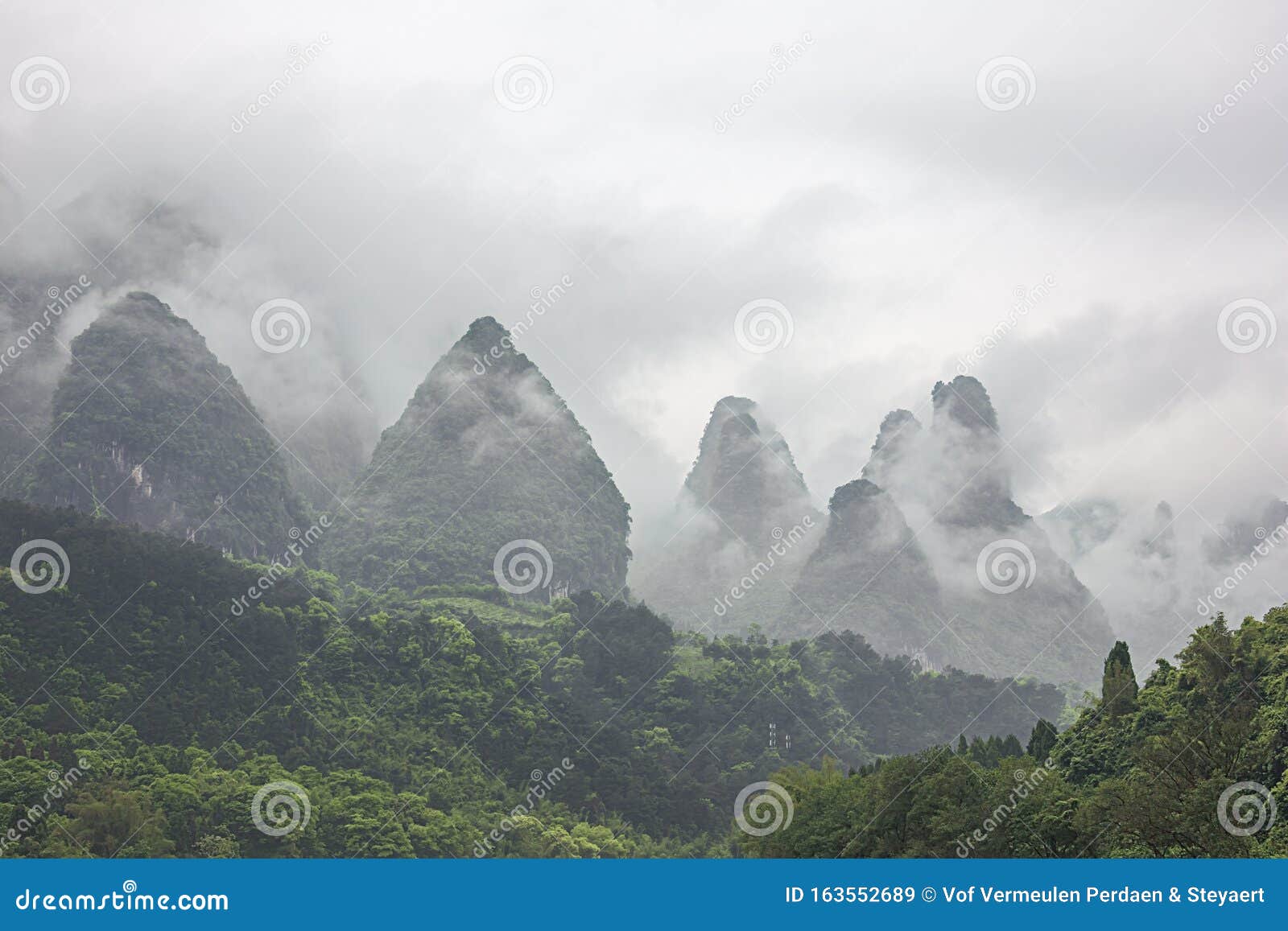 heavy clouds covering the hills bordering the li river