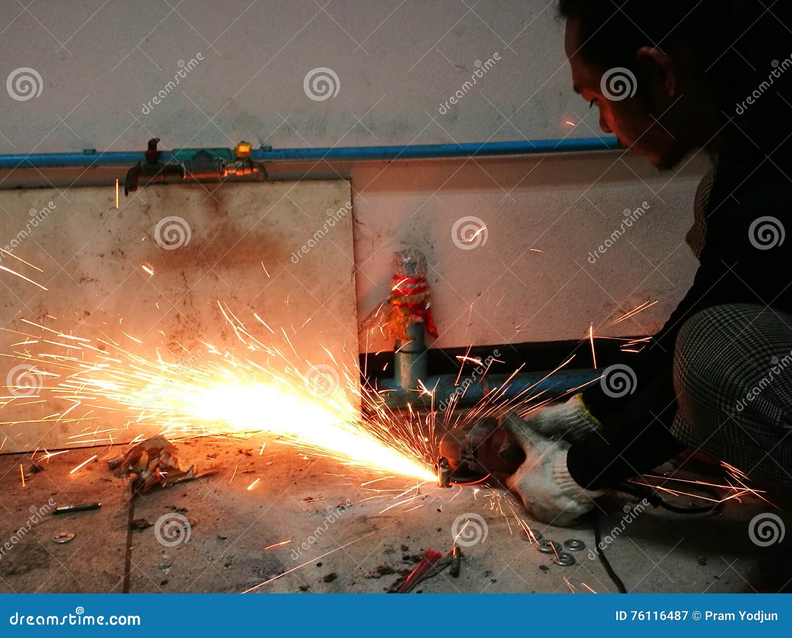 Heavy Industry Worker Cutting Steel with Angle Grinder Editorial
