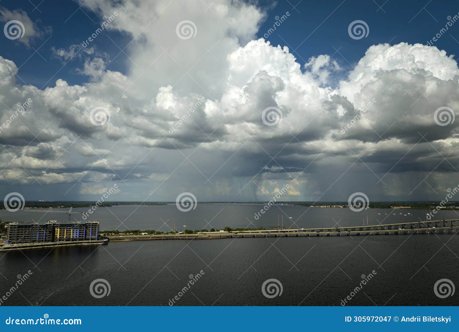 heavy thunderstorm approaching traffic bridge connecting punta gorda and port charlotte over peace river. bad weather