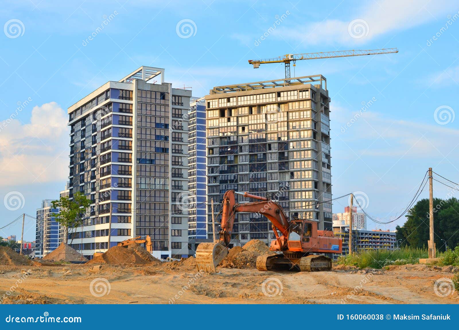 Heavy Tracked Excavator at a Construction Site on a Background of a  Residential Building and Construction Cranes on a Sunny Day Stock Photo -  Image of bulldozer, background: 160060038