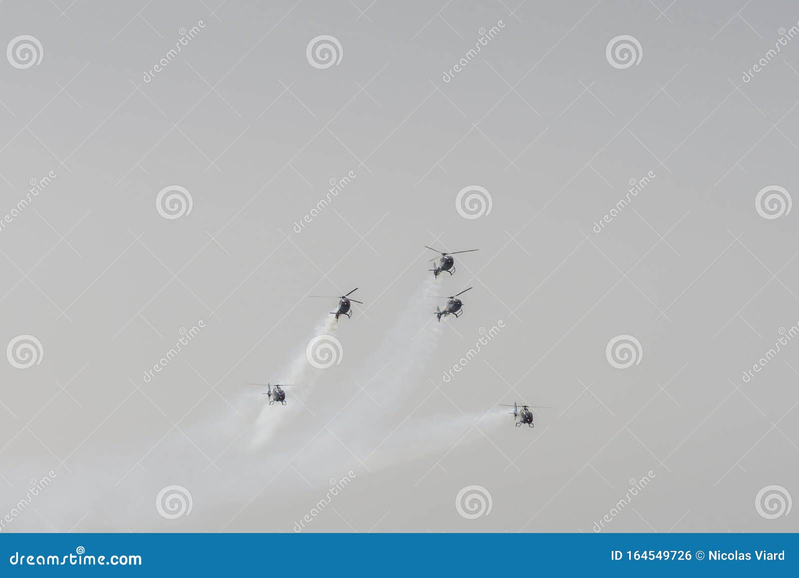 helicopter eurocopter colibri from the patrulla aspa patrol flying during the spanish airshow festival aereo internacional aga 75,