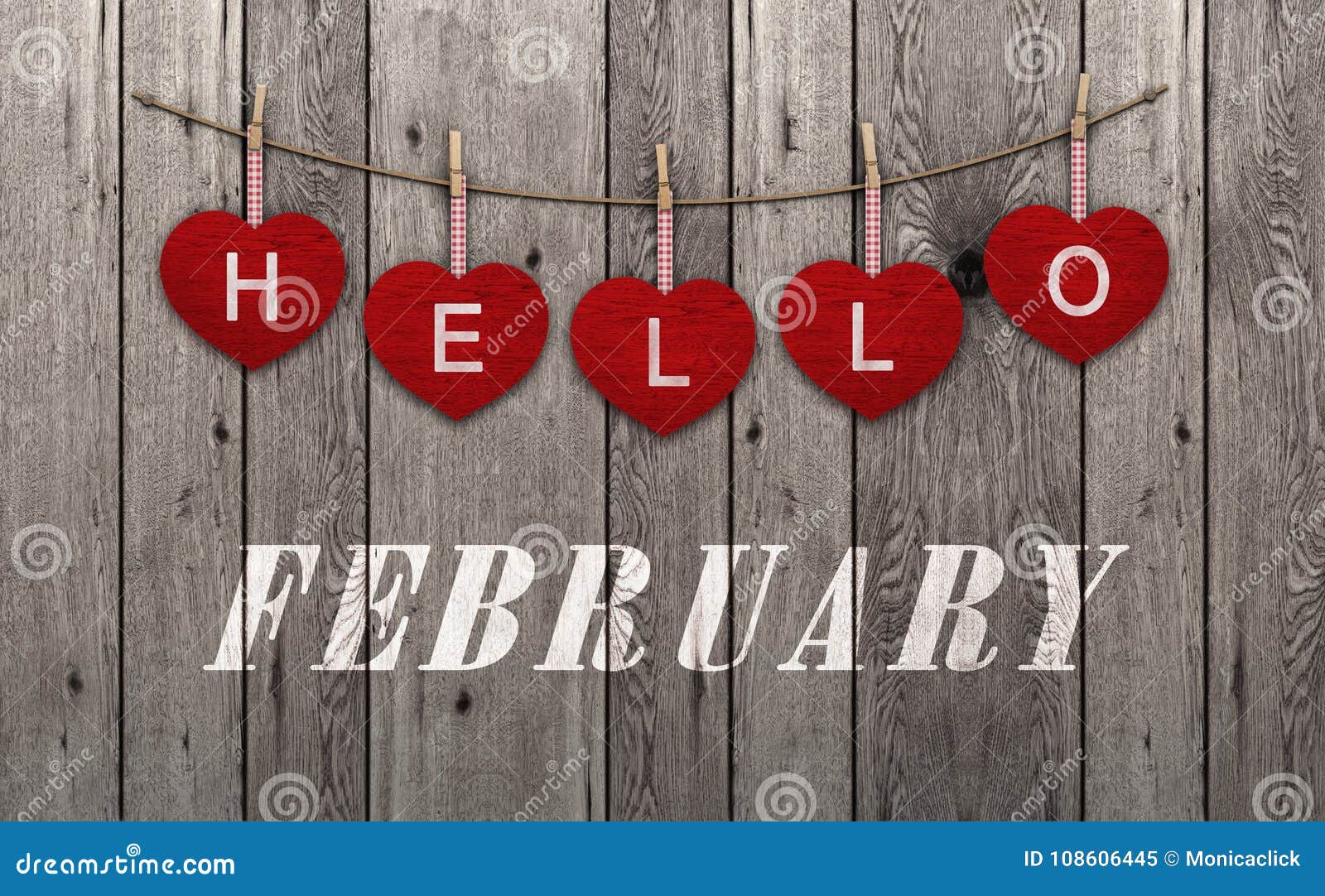 hello february written on hanging red hearts and old wooden background