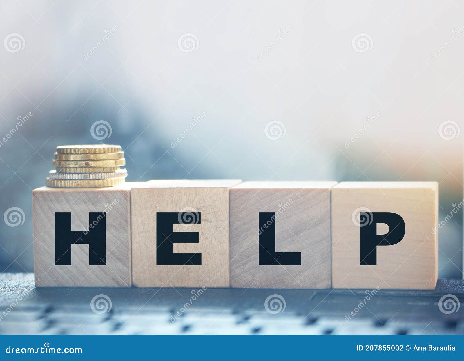 help - text on wooden cubes puton computer keyboard with stack of coins. donation and charity concept. business startup