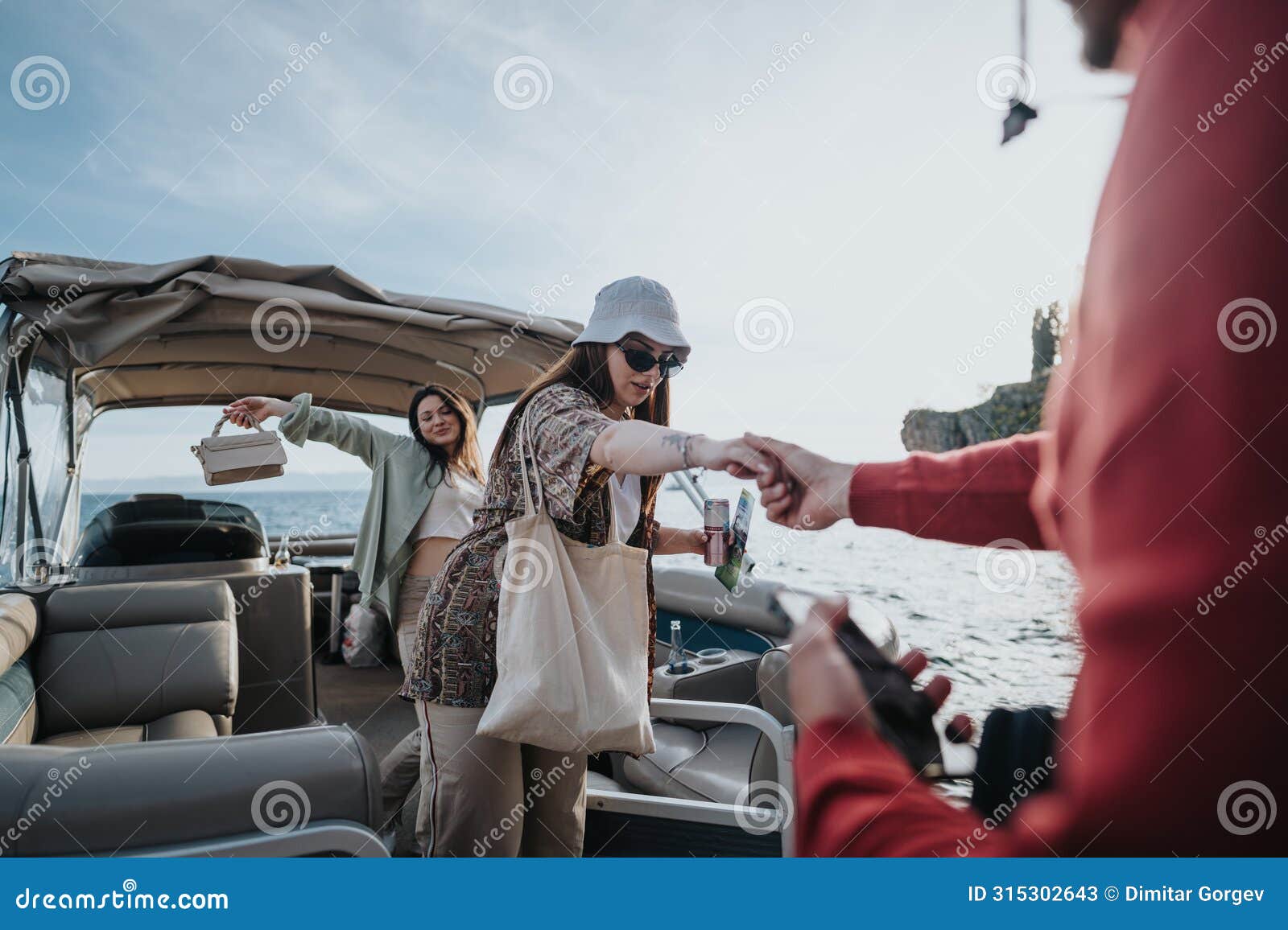 boatman assisting young woman disembarking from a boat with care