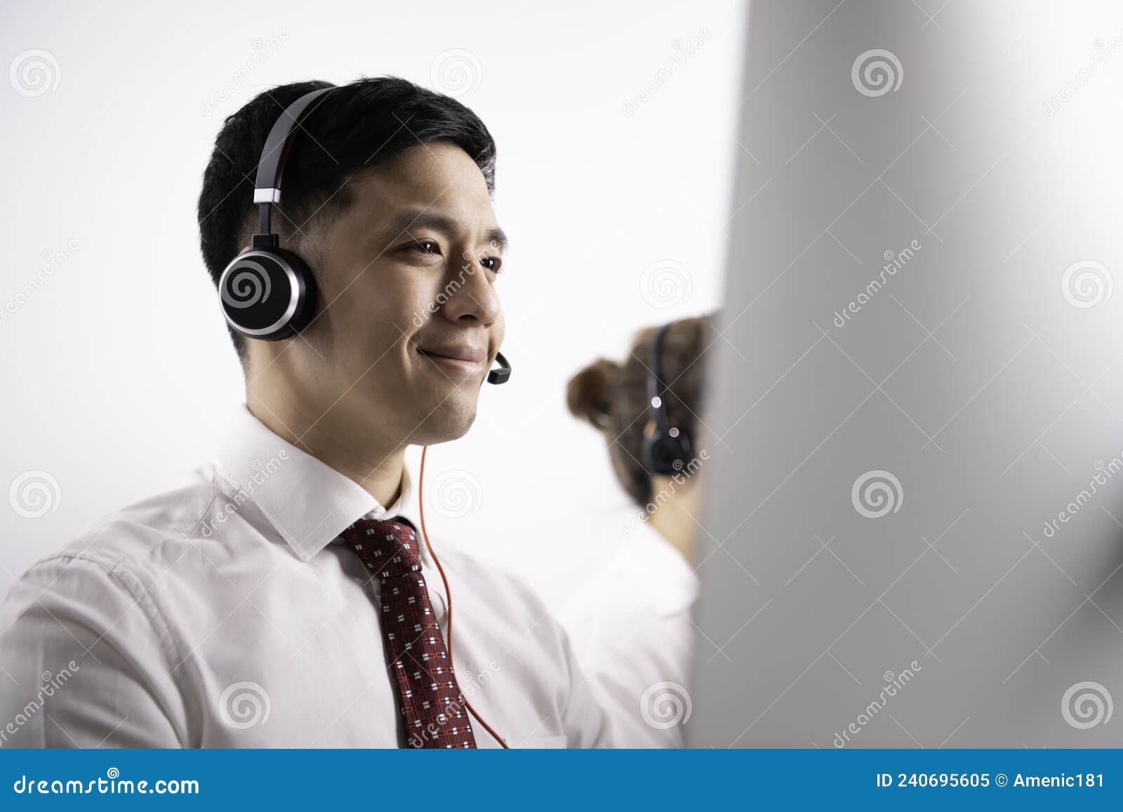 helpful operator dispatcher wearing headset assisting customers in customer support service taking phone calls at office