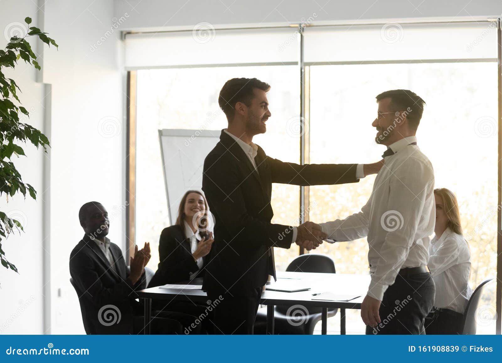 helpful proud boss handshaking praising male worker express appreciation