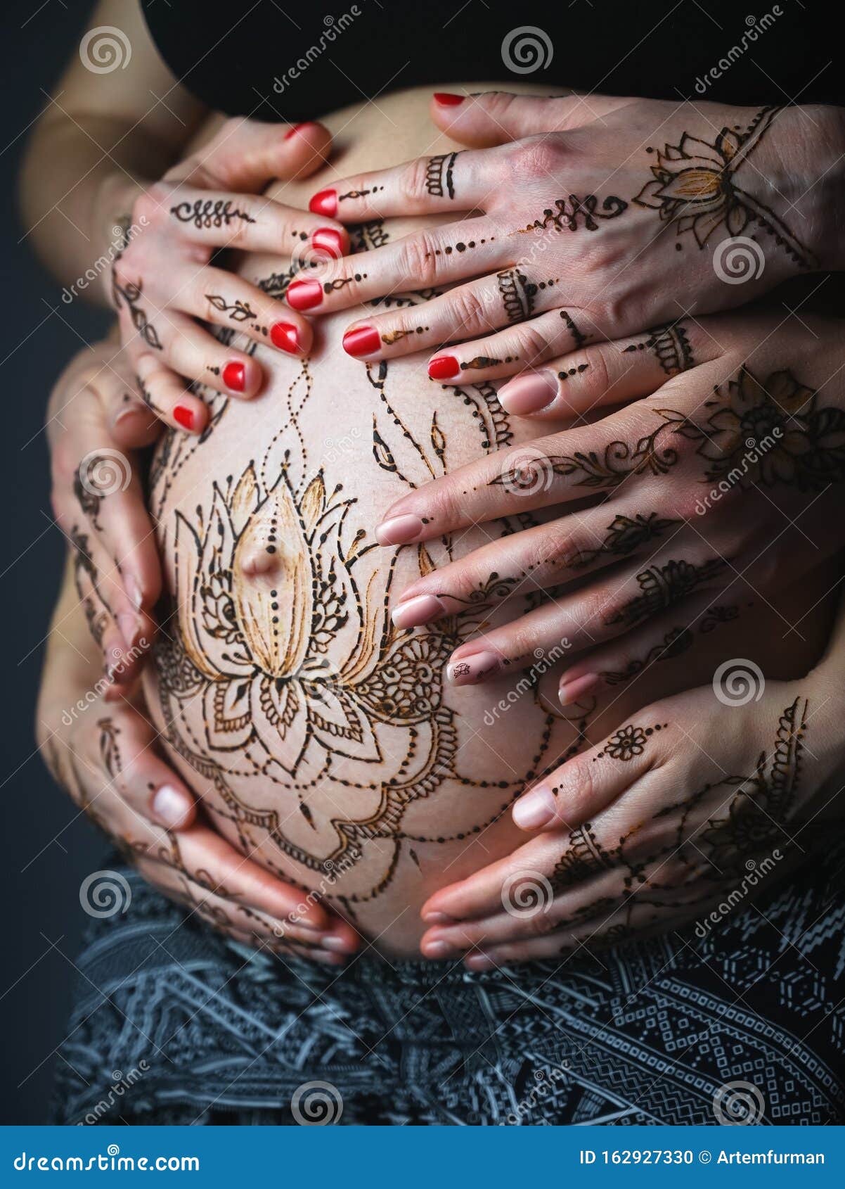 Premium Photo  Tattoo master drawing henna tattoo on pregnant belly closeup