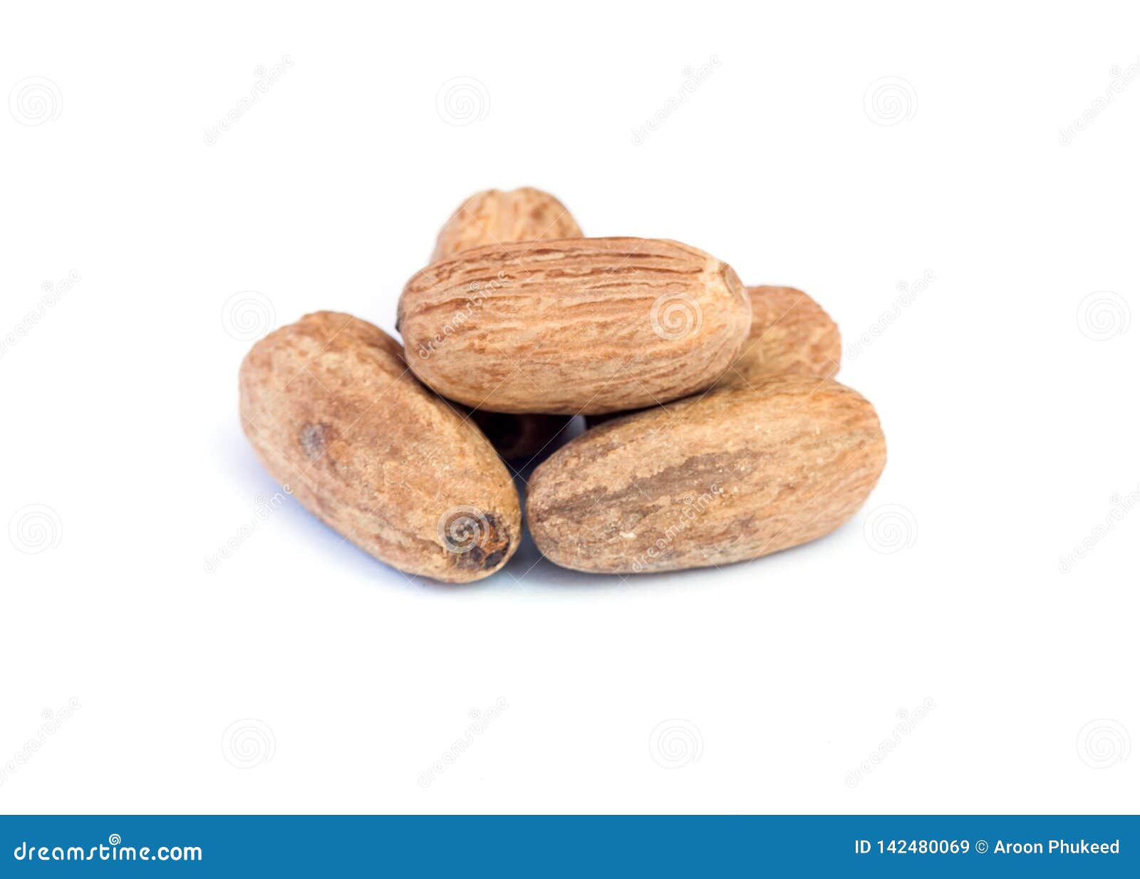 nutmeg on wooden over white background.